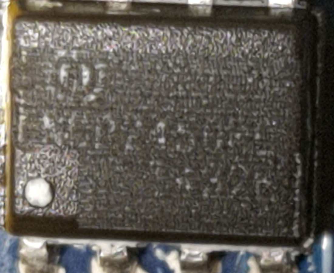 A photograph of the chip, with markings somewhat visible. Top left: a logo. Followed by what looks like NDP2540 with the last two characters unclear. Followed by 5-character long text near the bottom right, possibly ending in 32E. The dot is on the bottom left.